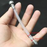 hand holding a part of Extended Long Metal Chastity Cage