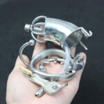 hand holding Extended Long Metal Chastity Cage