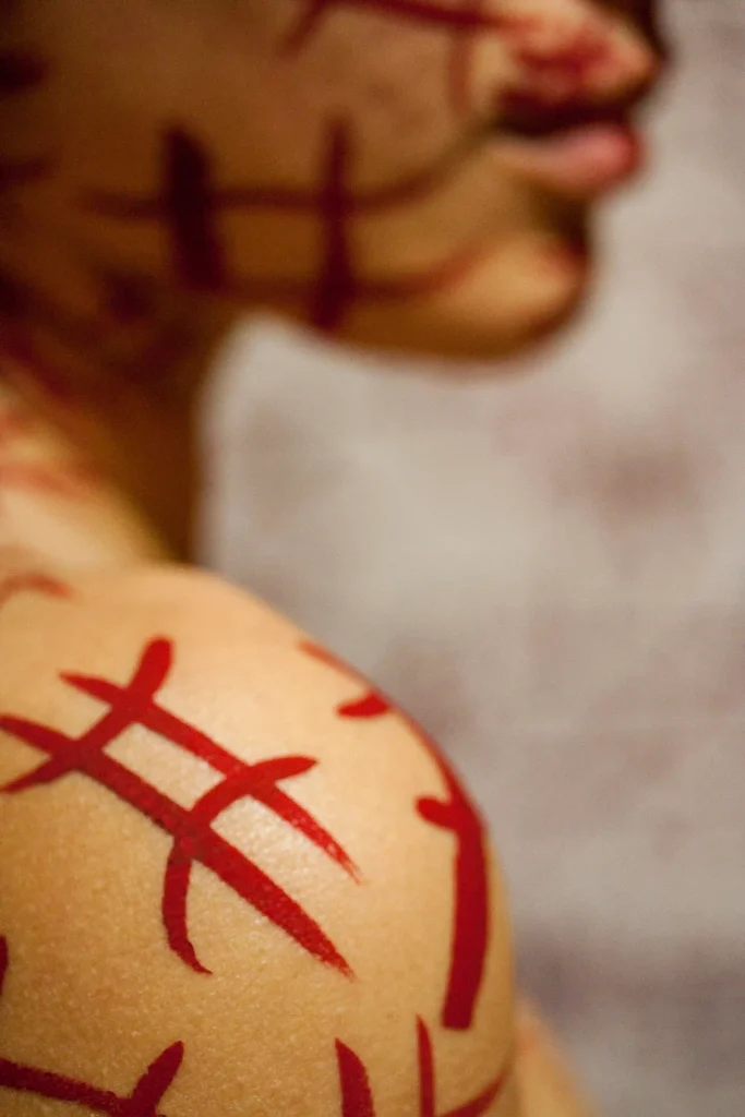 close-up-shoulder-with-painted-symbols-scaled-bdsm ideas