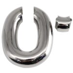 kinksterhub Heavy oval stainless steel testicle stretcher weighing 440 grams.