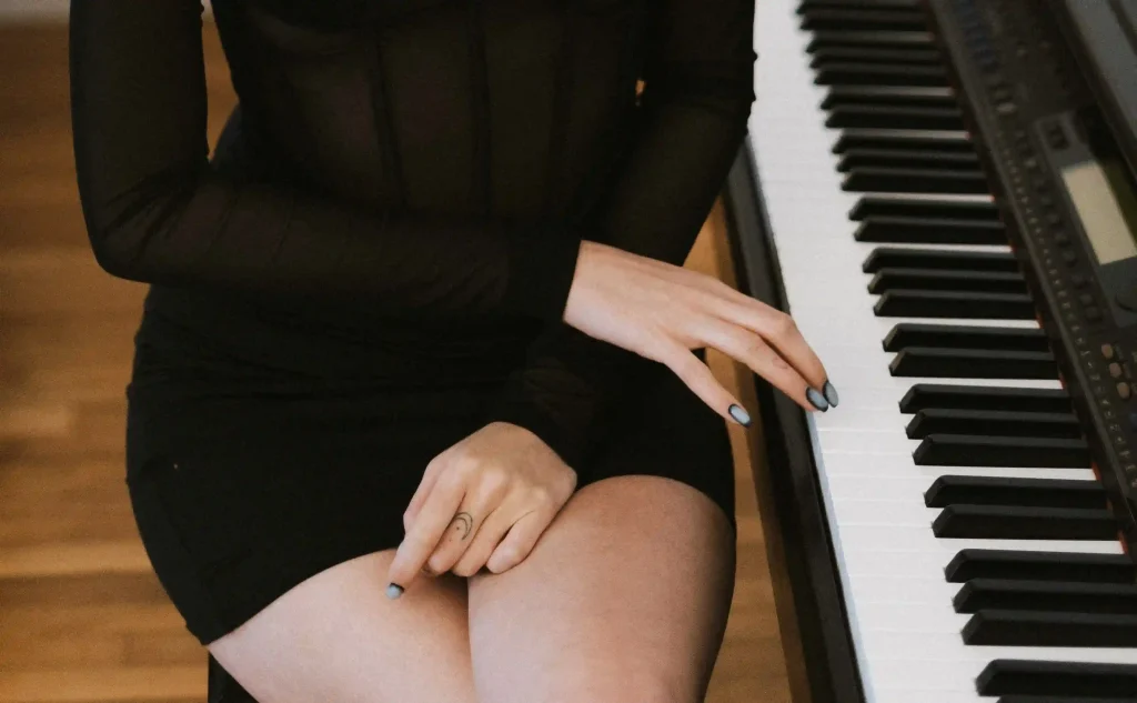 Beautiful girl with beautiful legs plays the piano