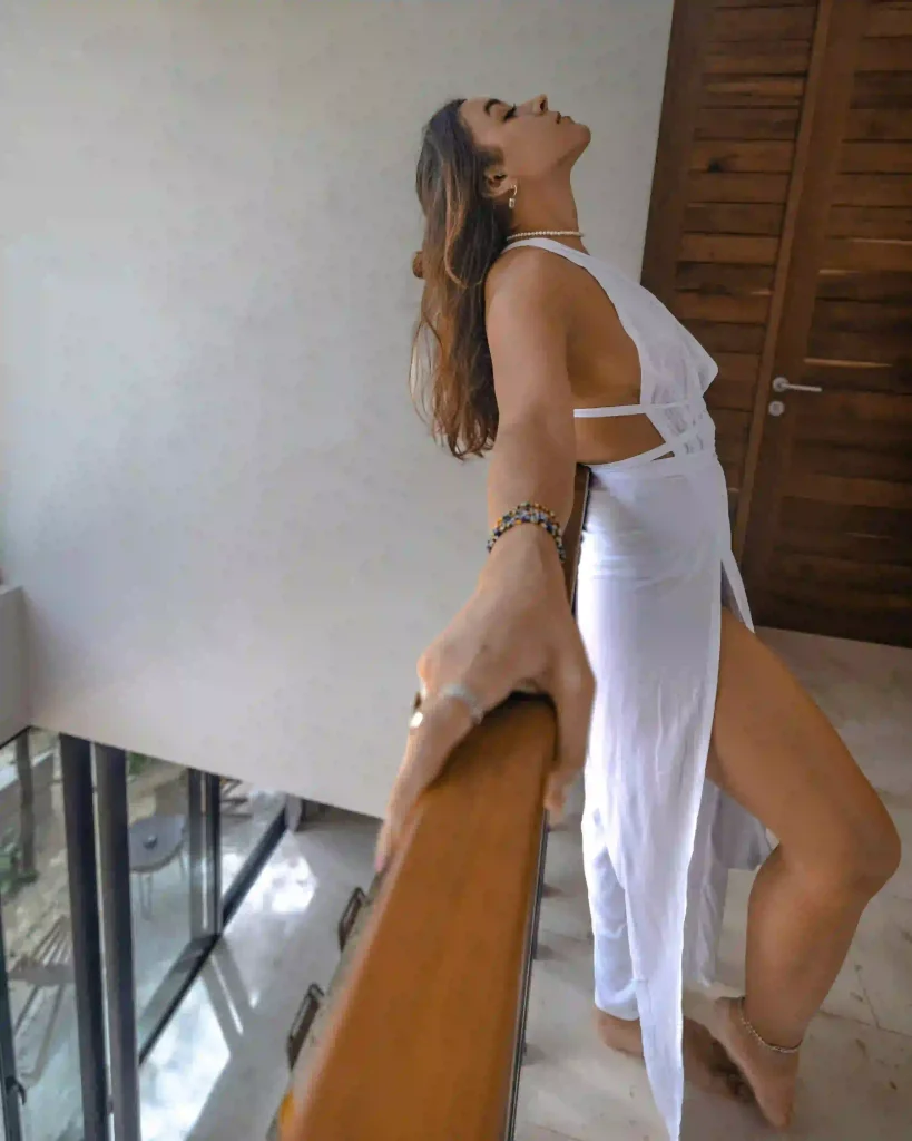 Beautiful woman in white leaning against the railing
